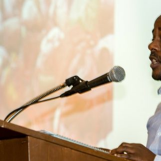 Amani Matabaro Tom speaking at the LA Jews for Refugees Assembly. Photo by Shlomit Levy Bard/HIAS